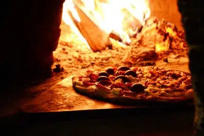 Close-up Photo of Pizza Near Bonfire
